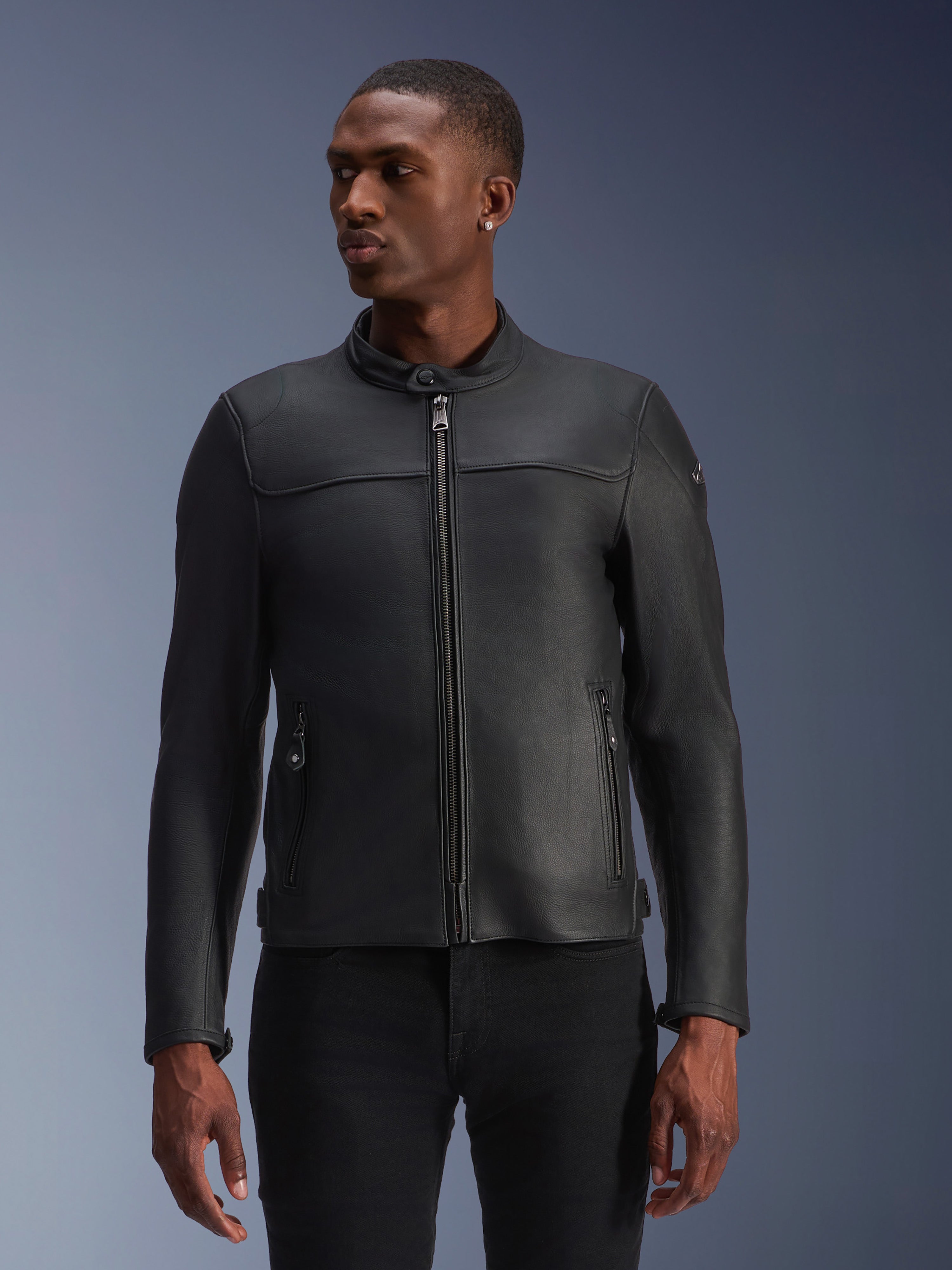 Alpinestars Blacktrack Leather Jacket, Black, Motorcycle Jacket, worn by a model, featuring a metallic front zipper, high collar, and zippered pockets, sleek premium leather construction for a modern minimalist look