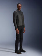 Male model wearing Alpinestars Blacktrack Leather Jacket, Black on Black, modern biker style with premium leather and metallic zip details, paired with black pants and boots for a contemporary urban look