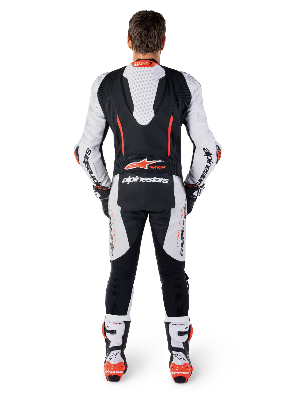 Alpinestars GP-R7 skinnställ, racingoverall i vitt och svart nötläder, vy bakifrån med aerodynamisk puckel och röd fluo-grafik.