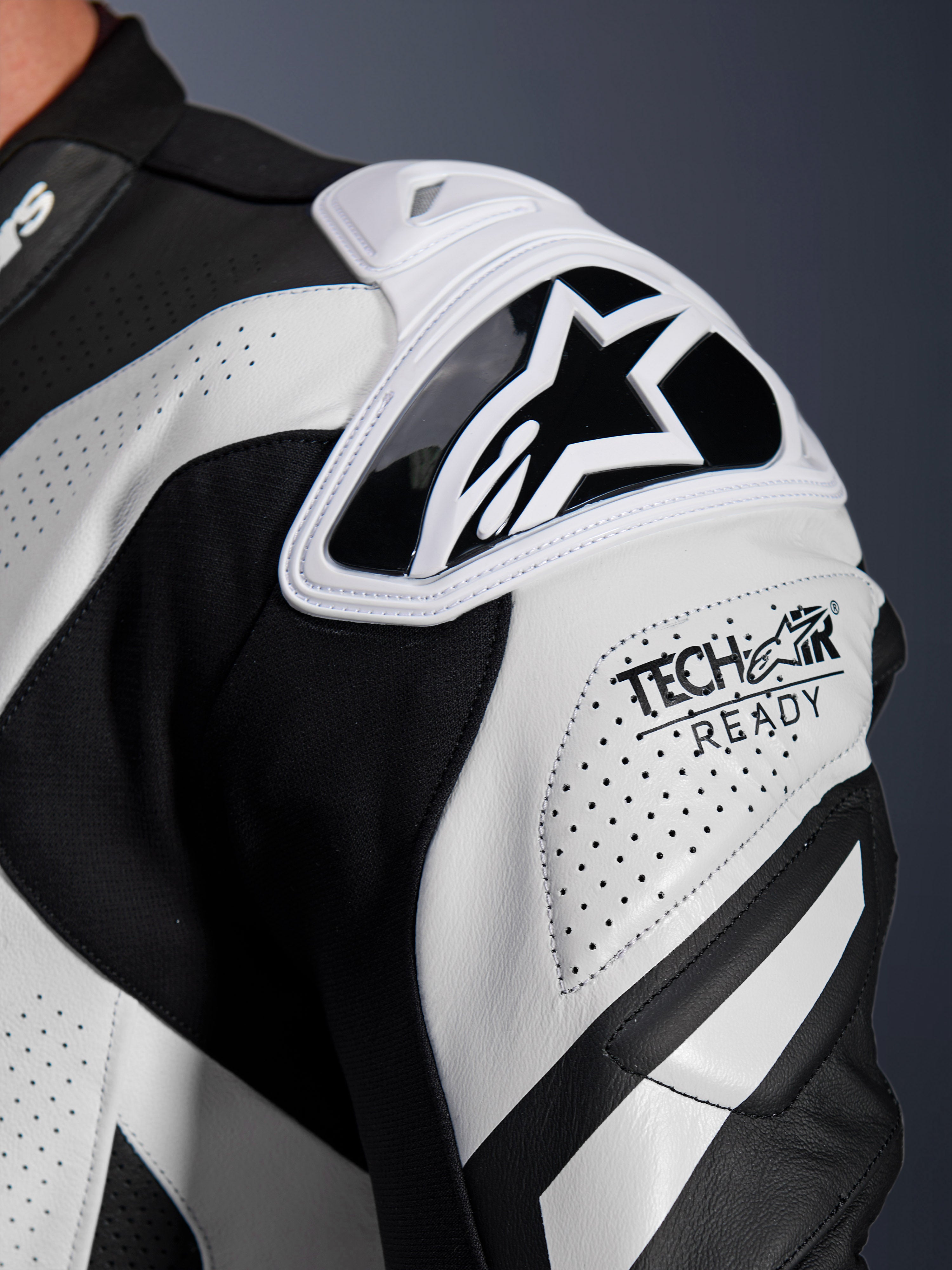 Alpinestars GP Plus V4 Sprint Leather Suit shoulder armor, black and white perforated leather with Tech-Air Ready logo.