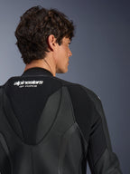 Alpinestars GP Force V2 Leather Suit 1-Piece, Black, close-up view of the upper back and aerodynamic speed hump, featuring white branding, perforated leather sections, and accordion stretch panels for performance racing.