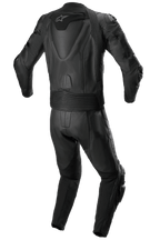 Alpinestars Missile V2 tvådelat skinnställ, racingskinnställ, helsvart, vy bakifrån som visar aerodynamisk ryggpuckel med vit stjärnlogotyp, dragspelsstretchpaneler vid midjan och axlarna, och perforerade läderdetaljer för högpresterande motorcykelkörning