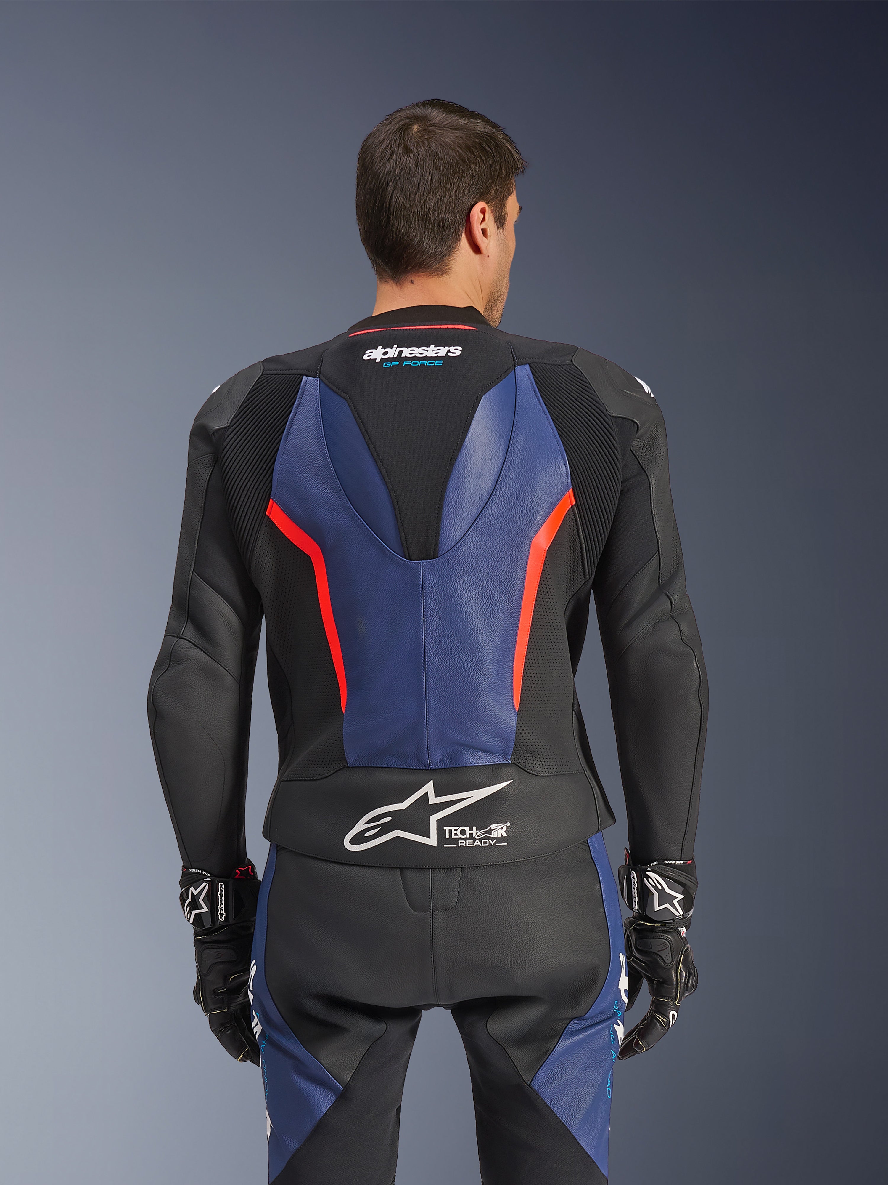 Alpinestars GP Force V2 läderställ, 2-delat, vy bakifrån, svart med blå och neonröda detaljer, perforerad läderkonstruktion, Tech-Air Ready-märkning i midjan och ergonomiska stretchpaneler för racingprestanda.