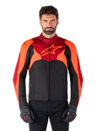 Alpinestars T-Jaws V4 Waterproof Jacket, Sport Textile Motorcycle Jacket, Black with Red Fluo and Dark Red accents, worn by a male model with matching gloves, technical riding gear with prominent star logo on the chest.