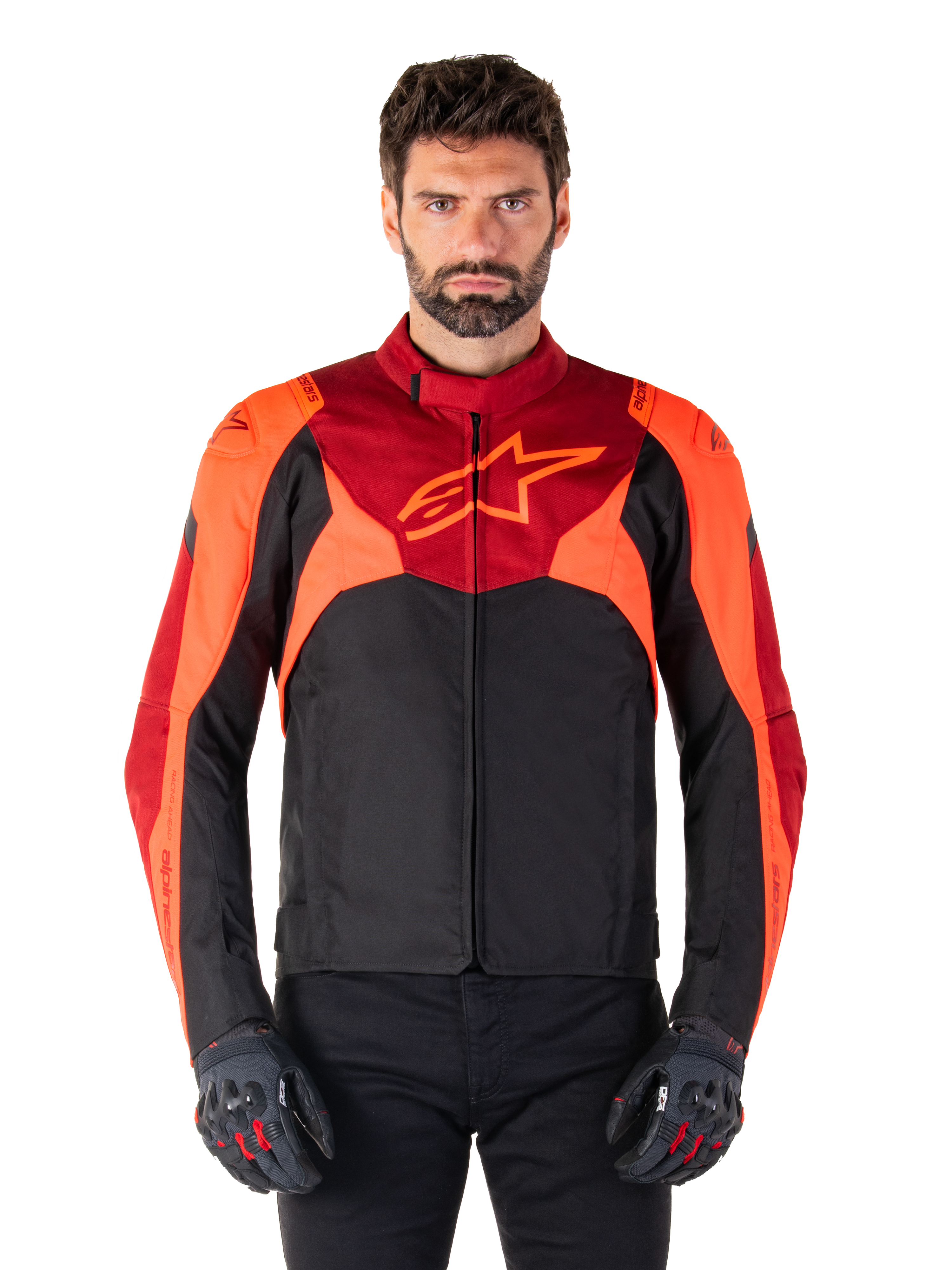 Alpinestars T-Jaws V4 Waterproof Jacket, Sport Textile Motorcycle Jacket, Black with Red Fluo and Dark Red accents, worn by a male model with matching gloves, technical riding gear with prominent star logo on the chest.