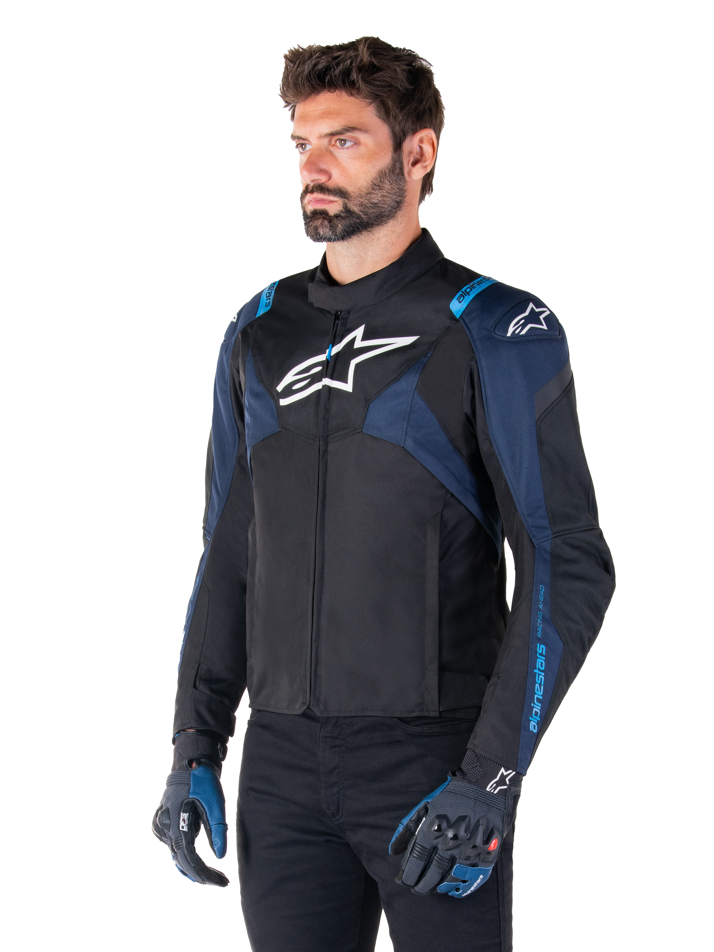 Alpinestars T-Jaws V4 Waterproof Jacket, Motorcycle Jacket, Black Dark Blue and Blithe Blue, worn by a model with matching gloves and black pants, featuring white Alpinestars logos on the chest and shoulders with blue accents on the sleeves, sporty textile riding gear
