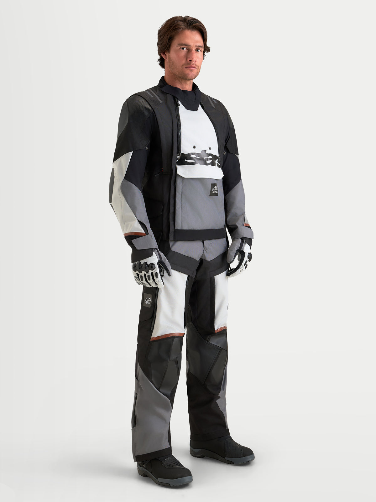 Alpinestars Harok V2 Drystar Gear Set, adventure touring motorcycle jacket and pants in black, gray, and white, worn by a male model with matching gloves, waterproof all-terrain riding apparel