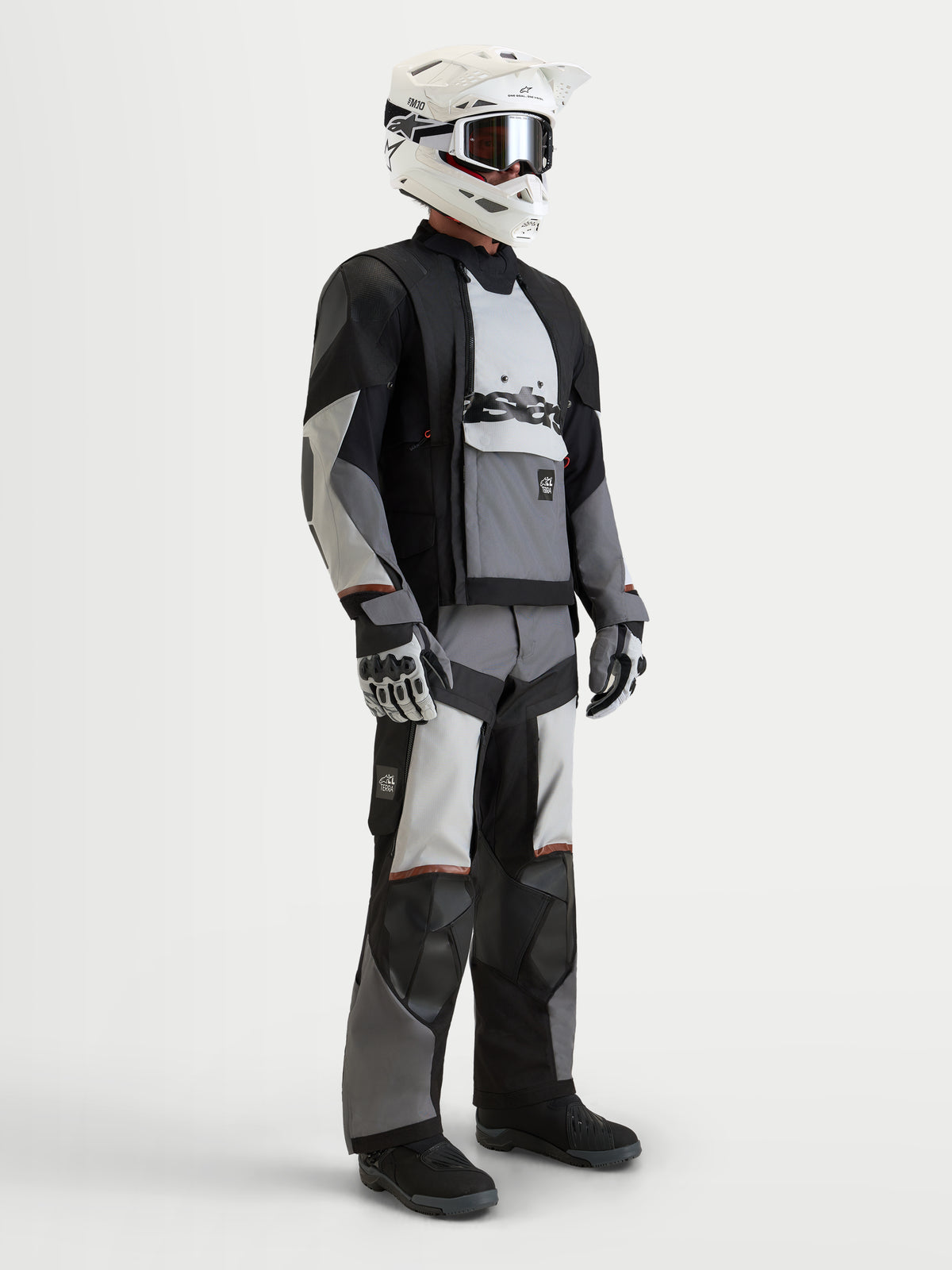 Alpinestars Harok V2 Drystar Gear Set, adventure touring motorcycle jacket and pants in black and light gray, worn by a model with a white helmet and matching gloves