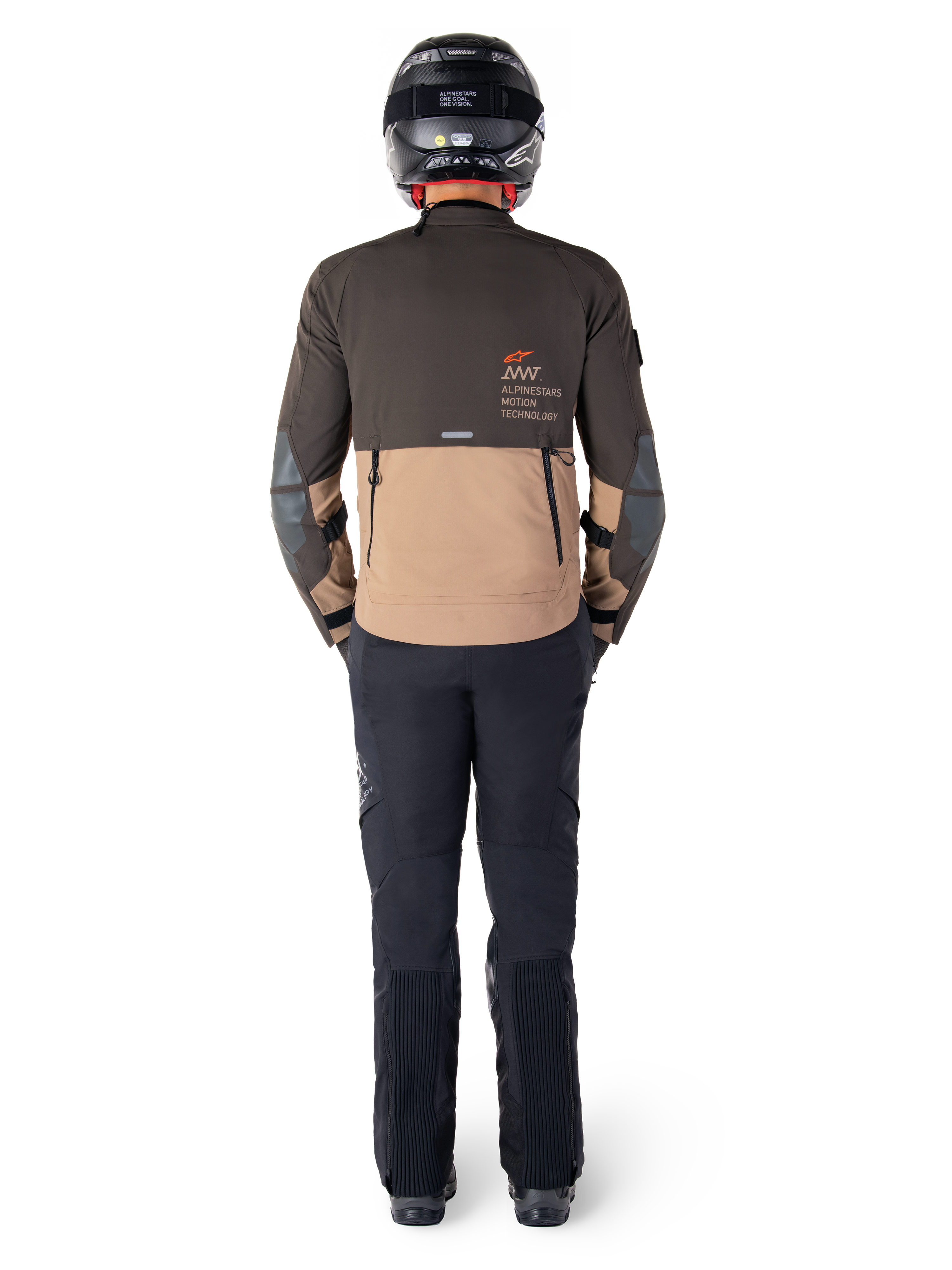 Alpinestars AMT-8 Stretch Drystar® XF-jacka, adventure touring-jacka, mörkbrun och mörkkaki, vy bakifrån som visar Alpinestars Motion Technology-logotyp på ryggen, bärs med svarta byxor och svart helhjälm, stretchigt prestandatextil för äventyrsmotorcykelutrustning