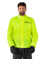 Alpinestars Hurricane Rain V2 jacka, motorcykelregnjacka, neongul, bärs av en modell med svarta byxor och handskar, hög krage med reflekterande detaljer, främre vindslå med Alpinestars-logotyp, vattentät utrustning med hög synlighet