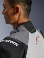 Alpinestars Andes V4 Drystar® Jacket, close-up of the collar and upper back, Dark Gray and Ice Gray with Black accents, red star logo, featuring a collar drawstring adjuster and Alpinestars branding, durable textile construction