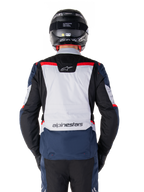 Alpinestars ST-1 Waterproof Jacket, Dark Blue Black and Bright Red, rear view showing light gray back panel and branding, adventure touring motorcycle jacket worn with black helmet and gloves, streamlined design for all-weather riding