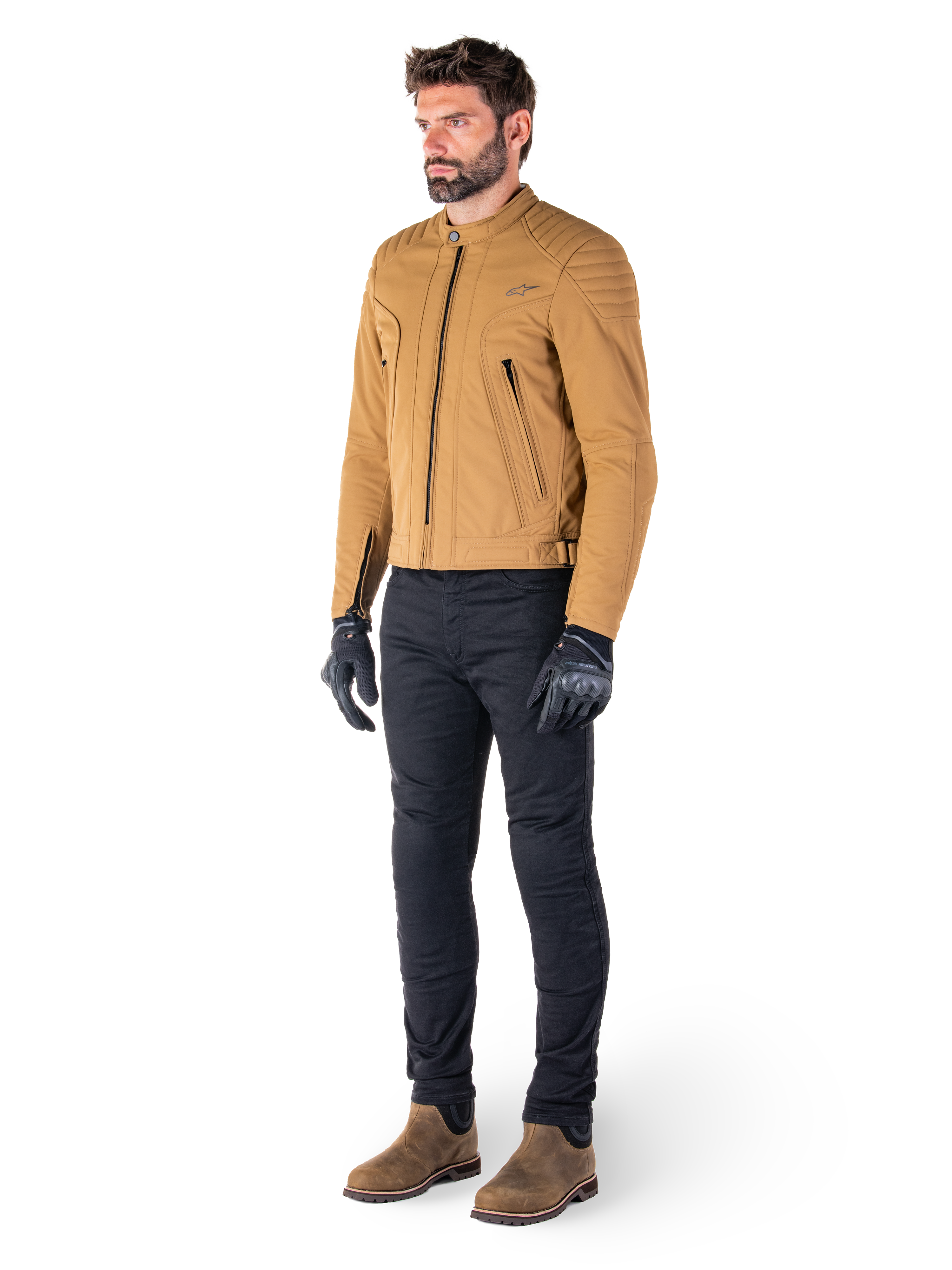 Male rider wearing the Alpinestars Clayton WR Jacket in Utility Brown Light Gold, urban contemporary motorcycle jacket with quilted shoulder details, styled with black pants, black gloves, and brown boots