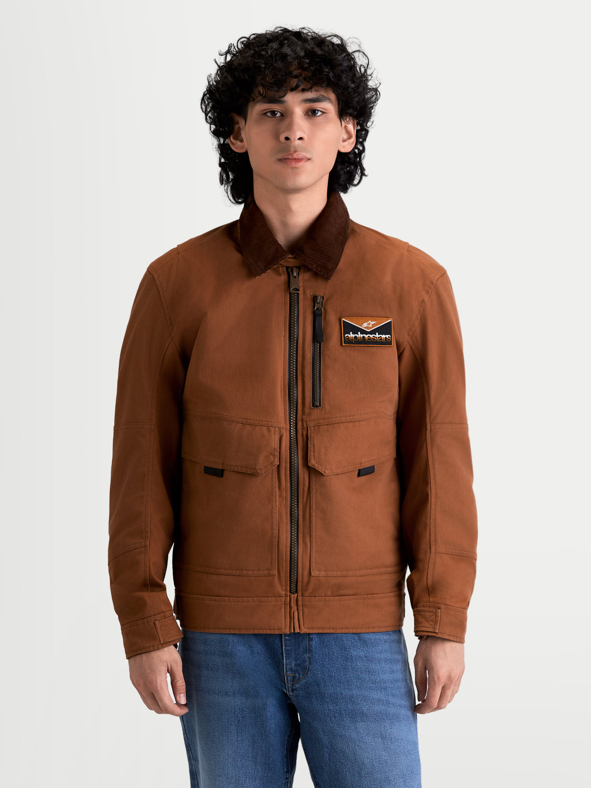 Alpinestars Mustang Waterproof Jacket, men's urban contemporary motorcycle textile jacket in dark rust and dark brown, front view on a model wearing workwear-styled riding apparel with a corduroy collar.