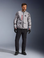Alpinestars Maxdura Drystar®XF Laminated Armored Shell, Adventure Motorcycle Jacket, Mid Gray and Dark Gray with red accents, worn with black riding pants and gloves, front view highlighting technical construction and large cargo pockets.