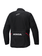 Alpinestars Honda ST-1 vattentät jacka, vy bakifrån, svart textil, med vit Alpinestars-stjärnlogotyp på övre delen av ryggen och Honda-logotyp på den bakre cargofickan, röda detaljer på sidorna, slitstark touring-motorcykeljacka