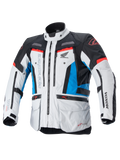 Alpinestars Honda Bogota Pro Drystar-jacka, touring MC-jacka, isgrå, blå och klarröd, teknisk textildesign med flera dragkedjor och fickor, justerbara remmar vid midja och ärmar, med Alpinestars- och Honda-logotyper, vattentätt och ventilerande allvädersskydd.