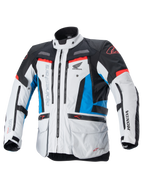 Alpinestars Honda Bogota Pro Drystar-jacka, touring MC-jacka, isgrå, blå och klarröd, teknisk textildesign med flera dragkedjor och fickor, justerbara remmar vid midja och ärmar, med Alpinestars- och Honda-logotyper, vattentätt och ventilerande allvädersskydd.