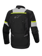 Alpinestars Bogotá Pro Drystar® jacka, adventure touring MC-jacka för herr, svart, isgrå och gul fluo, vattentät textil, vy bakifrån med ventilationspaneler och ryggficka.