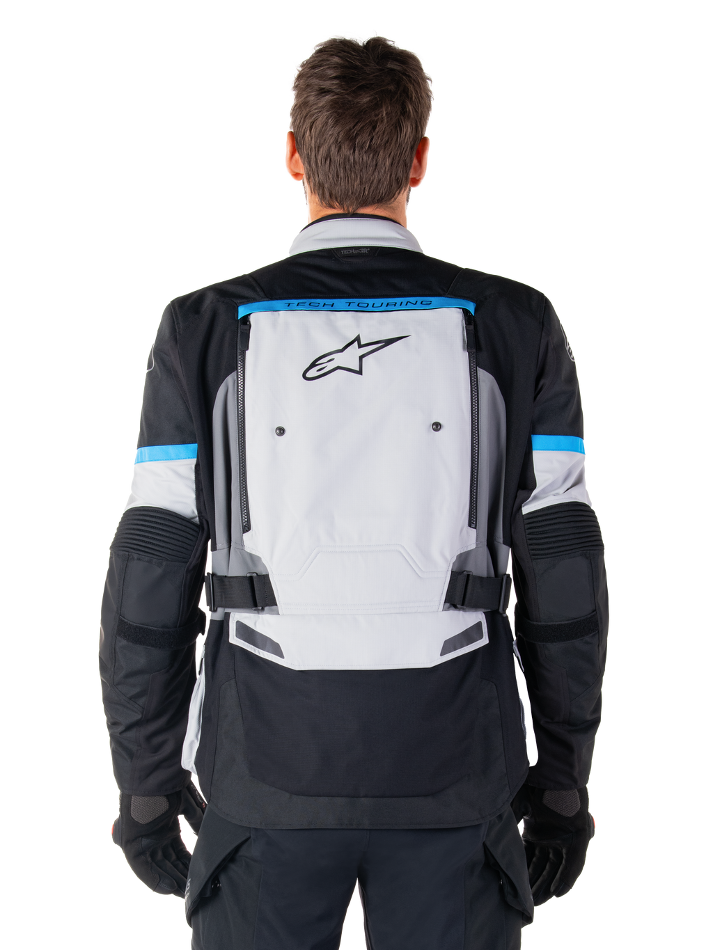 Alpinestars Bogota' Pro Drystar® jacka, äventyrsmotorcykeljacka, Ice Gray, svart och cyan, vy bakifrån med en stor ljusgrå panel med svart stjärnlogotyp, cyanfärgade detaljer med Tech Touring-branding och justerbara midjeremmar