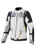 Alpinestars Stella Andes V4 Drystar® jacka för damer, adventure touring-jacka, isgrå och mörkgrå med svarta och neongula detaljer, slitstark textilkonstruktion med vattentäta dragkedjor och Alpinestars logotyp, framifrån