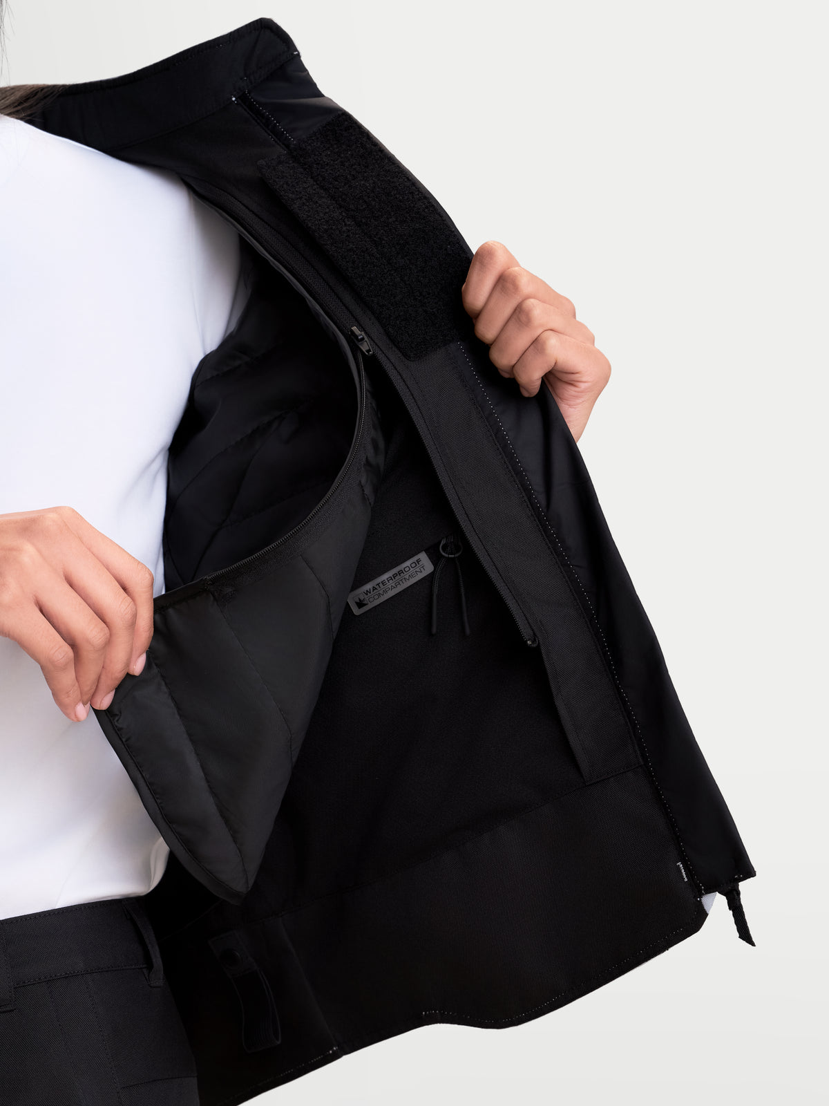 Alpinestars Stella C-1 Waterproof Jacket, women's urban motorcycle jacket in ice gray and black, close-up view showing the internal waterproof compartment and detachable thermal vest insulation