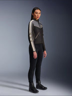 Alpinestars Stella T-Dyno WR Jacket, Women's textile motorcycle jacket, Black, Dark Gray, and Ecru, featuring vintage-inspired design with cream sleeve stripes and star logos, worn with black pants and riding boots, heritage-inspired urban riding gear