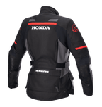 Alpinestars Stella Honda Andes V3 Drystar® jacka för dam, motorcykeljacka för äventyr, svart, grå och klarröd, vy bakifrån med framträdande vit HONDA-logotyp och röd Alpinestars-grafik, vattentät textilkonstruktion med justerbar midja och praktiska fickor