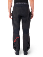 Alpinestars Hyde XT Drystar® Pants, Adventure Motorcycle Pants, Black with red star logo on the lower leg, back view, over-the-boot enduro design with durable textile panels and branded waistband.