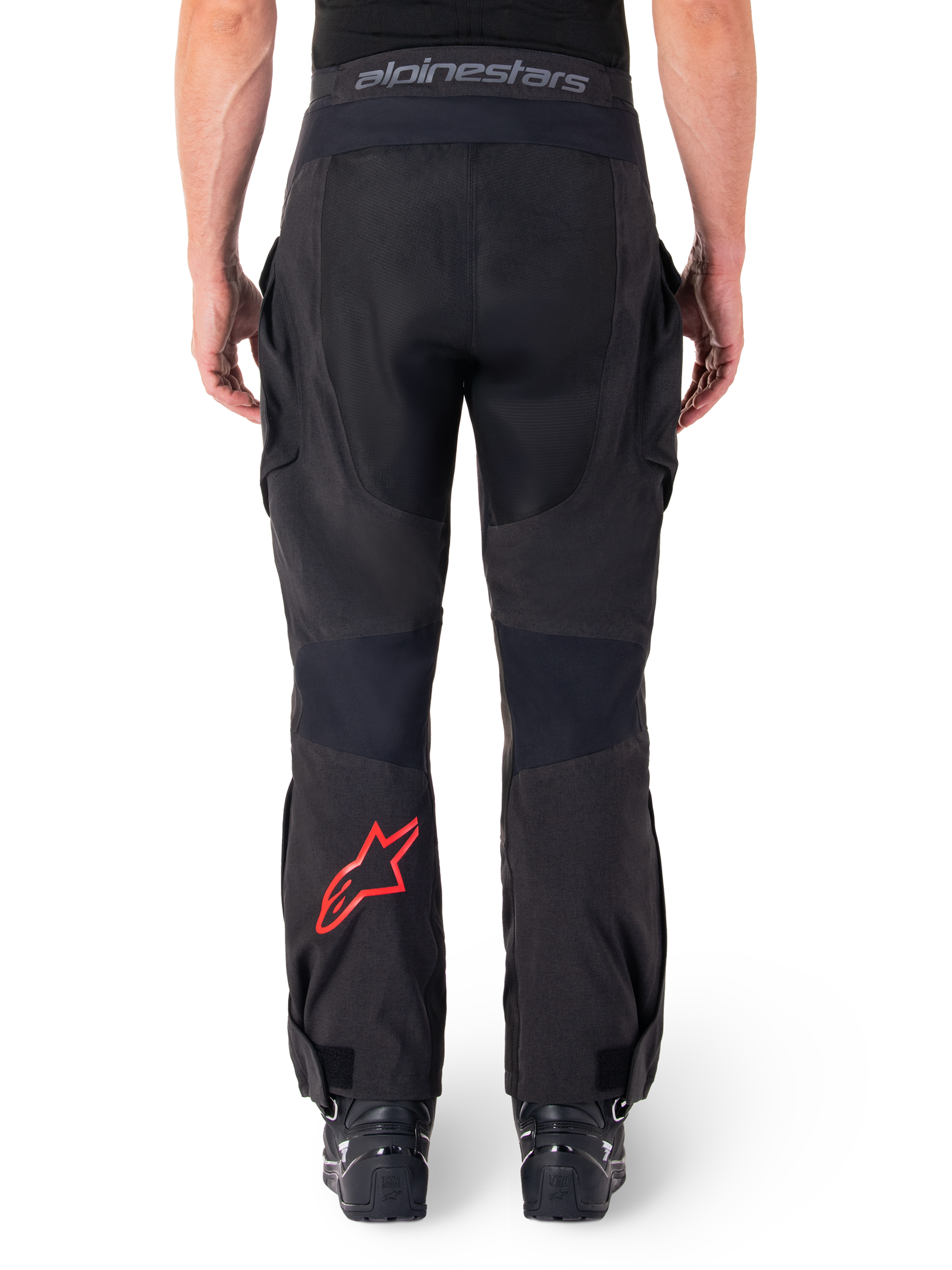 Alpinestars Hyde XT Drystar® Pants, Adventure Motorcycle Pants, Black with red star logo on the lower leg, back view, over-the-boot enduro design with durable textile panels and branded waistband.