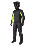 Alpinestars Bogota' Pro Drystar® 3 Seasons Pants, Black, rider wearing full adventure touring gear including a black jacket with neon yellow accents, black helmet, gloves, and boots, featuring the waterproof Drystar® membrane worn over the pants