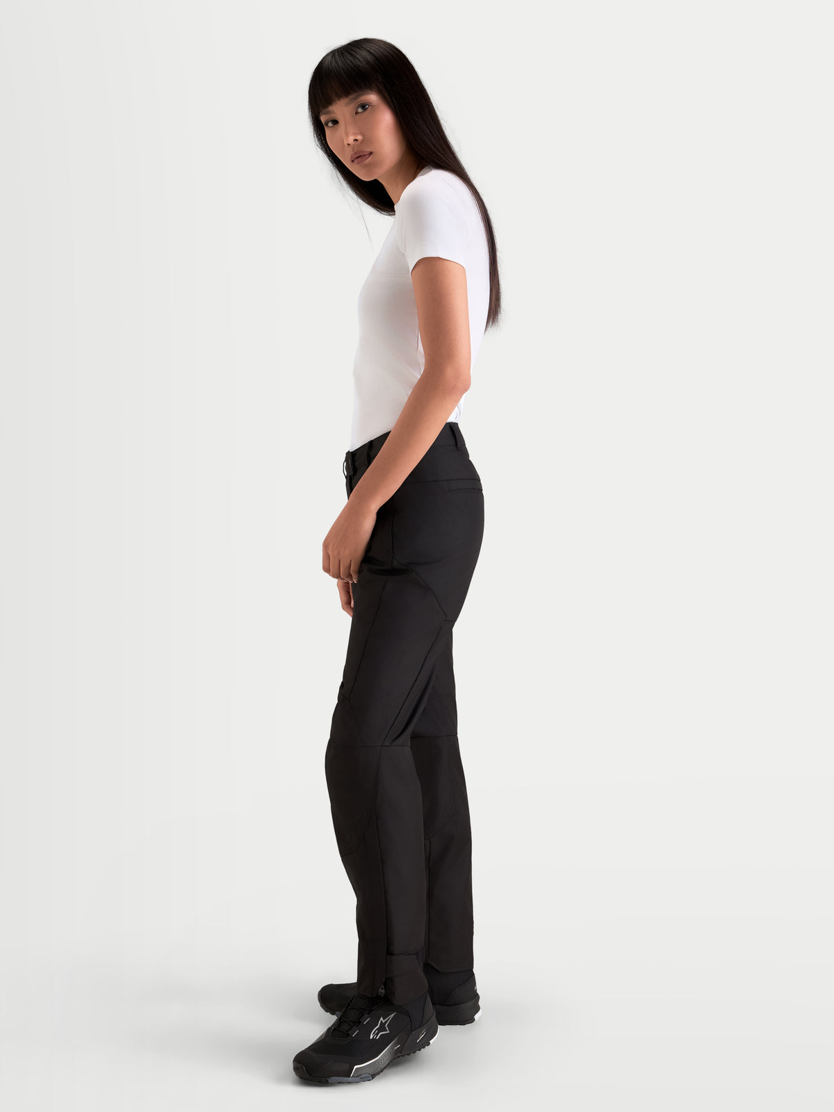 Alpinestars Stella C-1 Waterproof Pants, women's urban contemporary motorcycle pants in black, side profile view worn by a model