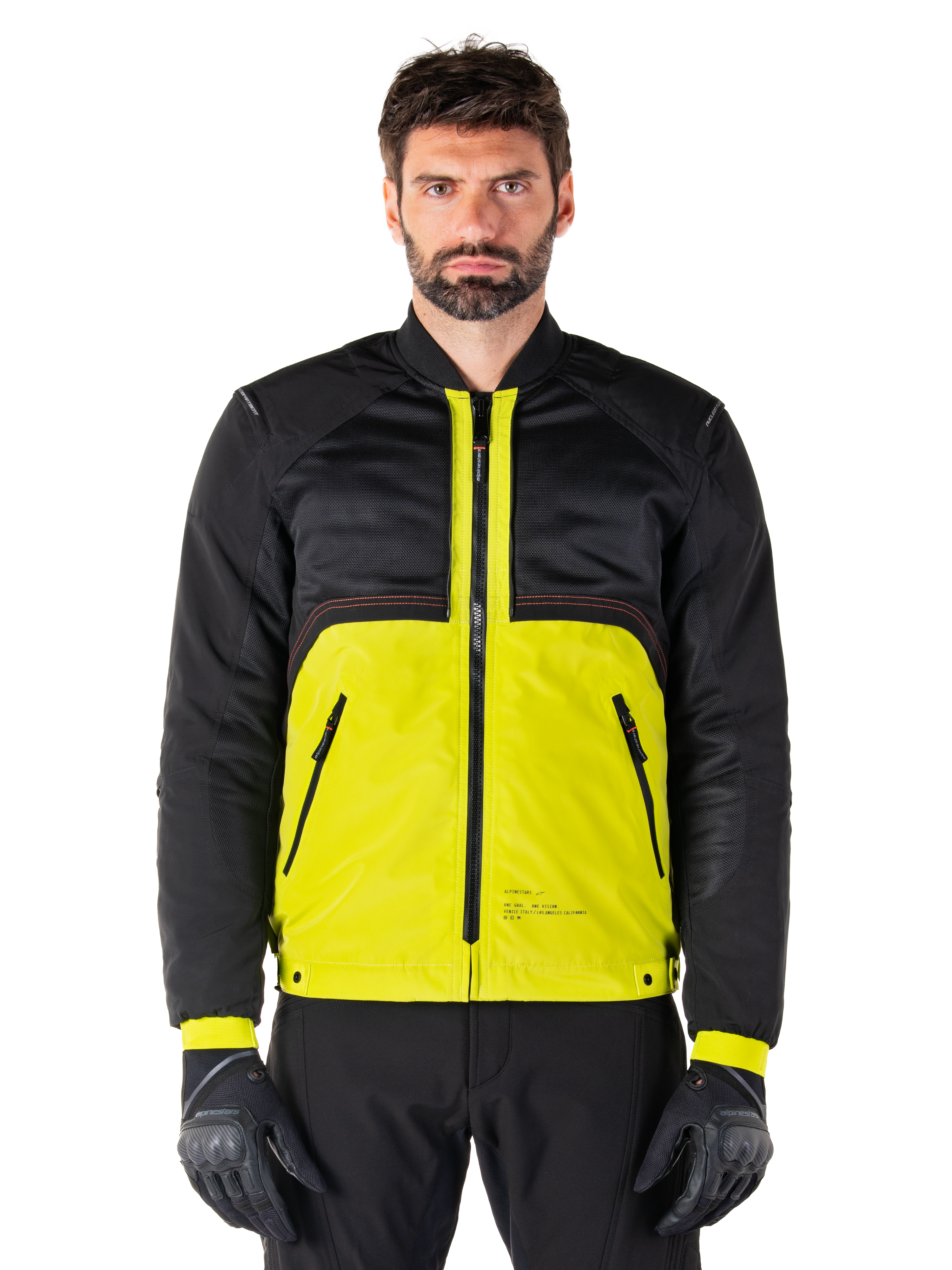 Mootant Waterproof Parka, modular motorcycle jacket, Lime Punch and Black, worn by a male model with black gloves and pants, featuring a vibrant yellow lower body and black upper torso and sleeves, utilitarian design for all-weather riding