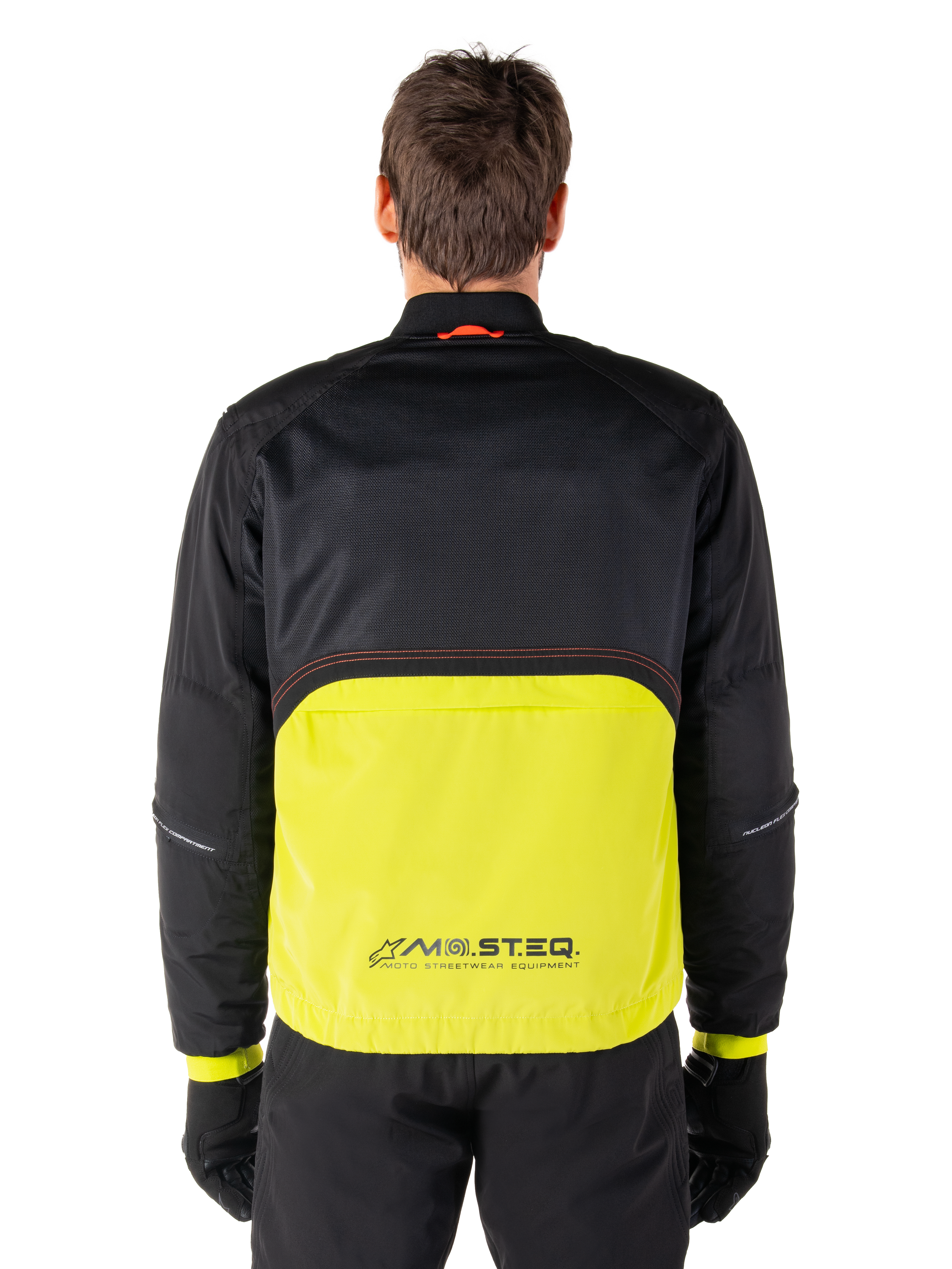 Alpinestars Mootant Waterproof Parka, Motorcycle Jacket, Lime Punch and Black, back view featuring black mesh upper for ventilation and lime lower section with MO.ST.EQ. logo, worn with black pants and gloves