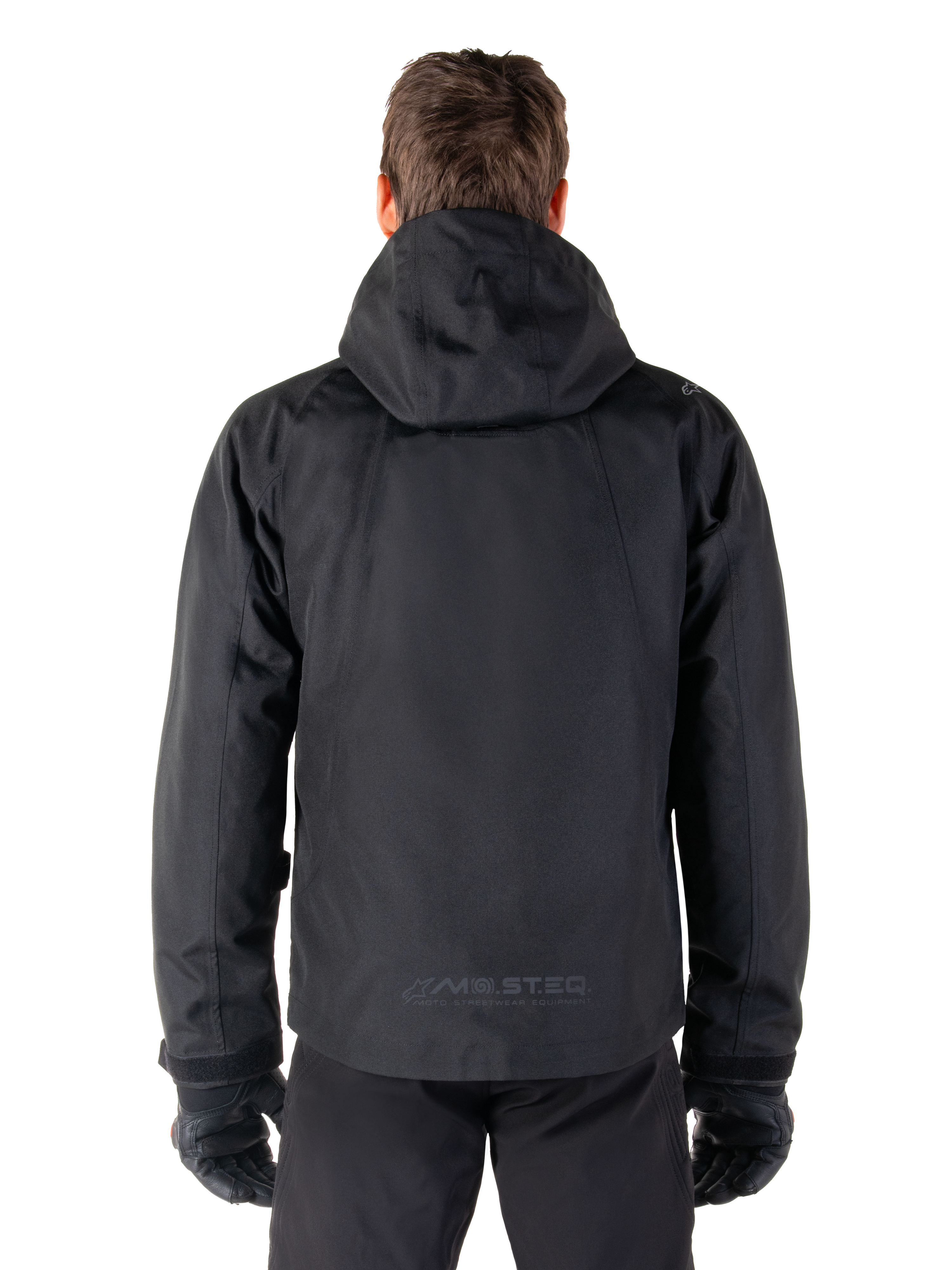 Alpinestars Morush Waterproof Parka, Black, rear view showing the hood and MO.ST.EQ. reflective logo on the lower back, minimalist urban motorcycle jacket with a streetwear-inspired design, textile riding gear for men.