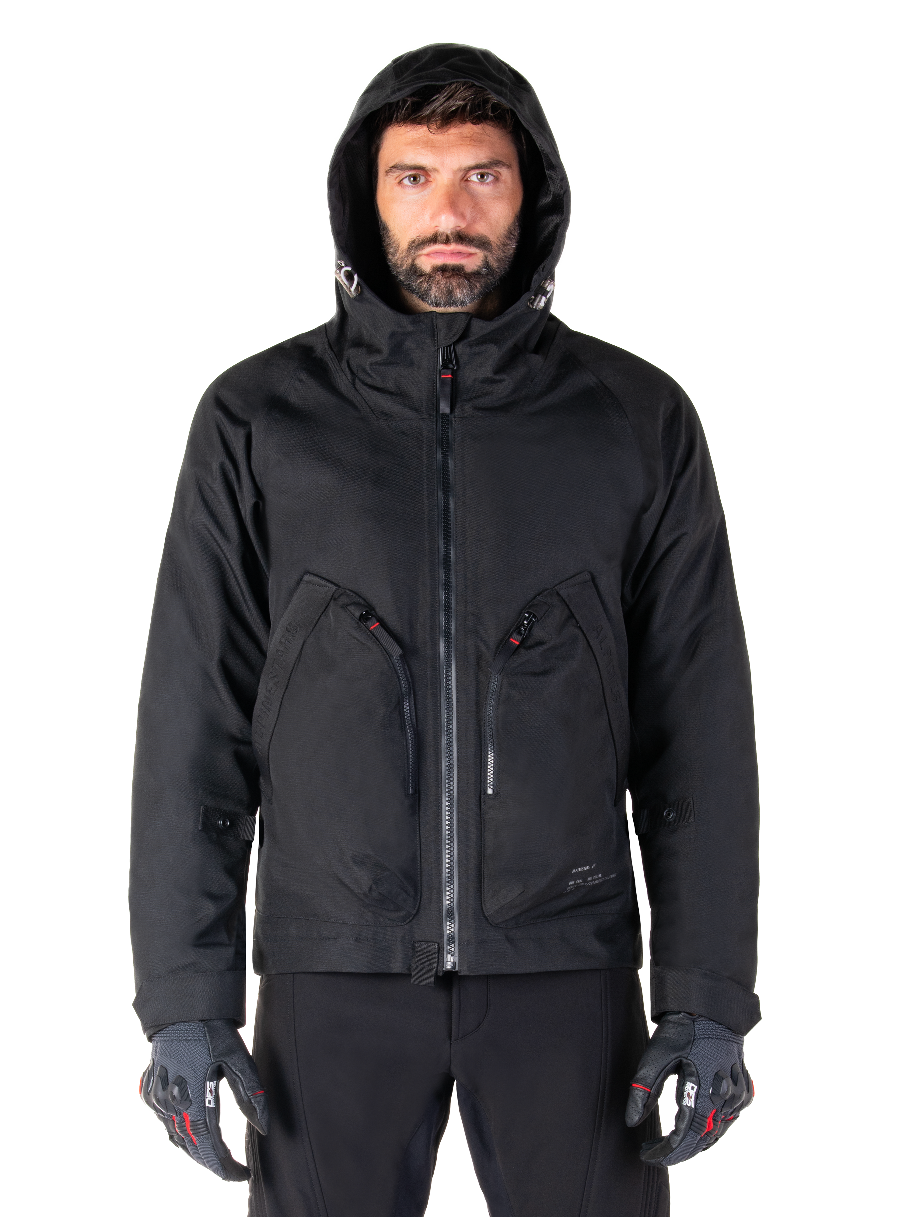 Alpinestars Morush Waterproof Parka, Black, Urban motorcycle jacket with a hood and large front utility pockets, worn by a model with protective riding gloves, minimalist and contemporary streetwear-inspired design.