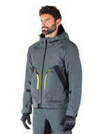 Alpinestars Morush Waterproof Parka, Urban Gray motorcycle jacket, hooded design with bright yellow zipper accents, black pocket detailing, worn with matching gray riding pants and black gloves, contemporary streetwear-inspired motorcycle apparel.