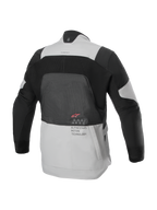 Alpinestars AMT-7 Air Jacket, rear view, Tan and Dark Shadow, technical motorcycle jacket with large MATRYX® mesh panel on the back, 'Alpinestars Motion Technology' text, and red logo, designed for summer adventure touring