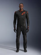 Alpinestars Viper Air V4 Jacket in Black Red Fluo, worn by a model with matching black pants and gloves, featuring mesh panels for airflow and a prominent red Alpinestars logo on the chest, sporty motorcycle road gear.