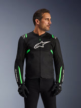 Alpinestars T-SPS Air V2 Jacket, Motorcycle Jacket, Black and Fluo Green, worn by a model with black riding gloves and pants, featuring white Alpinestars logo on the chest and neon green accents on shoulders and sleeves, tech mesh panels for ventilation, sport-cut design for urban riding