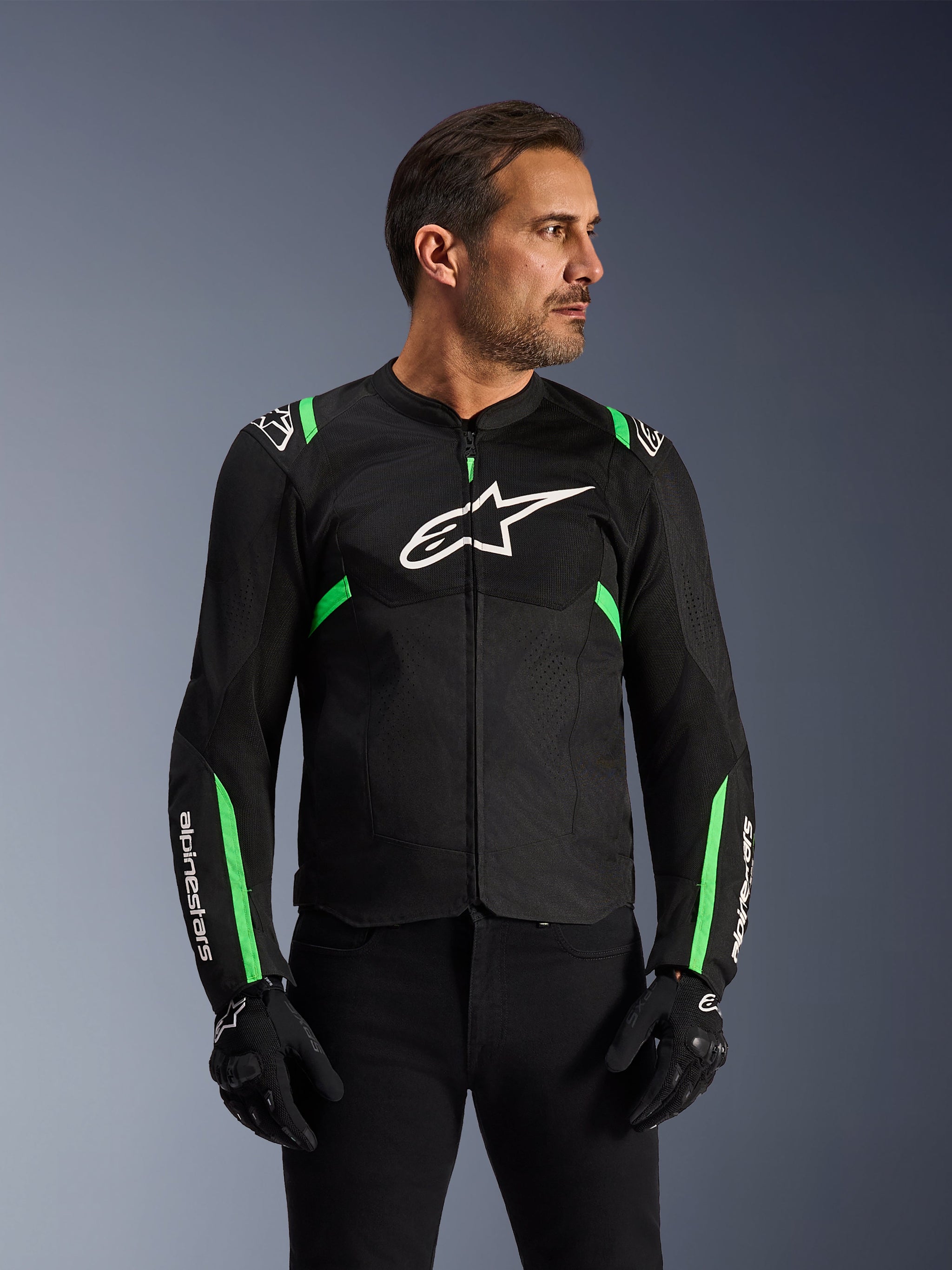 Alpinestars T-SPS Air V2 Jacket, Motorcycle Jacket, Black and Fluo Green, worn by a model with black riding gloves and pants, featuring white Alpinestars logo on the chest and neon green accents on shoulders and sleeves, tech mesh panels for ventilation, sport-cut design for urban riding
