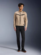 Alpinestars Bruiser Jacket, Urban Motorcycle Jacket in Aluminum, worn with black pants and black sneakers, featuring black zippered pockets and a snap collar, contemporary workwear-inspired design for urban riding