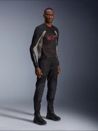 Alpinestars Troop-Air Jacket, technical mesh motorcycle jacket in Black, Ash Gray and Bright Red, worn by a model with matching black pants and boots, featuring a red Alpinestars logo on the chest, urban contemporary riding gear.