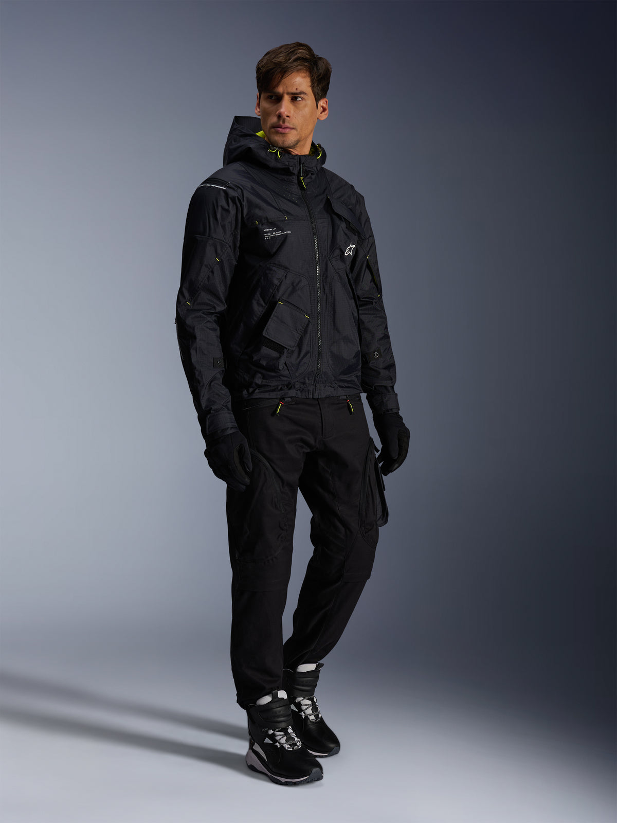 Alpinestars Mogress Air Jacket, Urban Motorcycle Jacket, Black with Lime Punch and White accents, worn with black riding pants, gloves, and black and white boots, contemporary utility-inspired design.