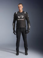 Alpinestars T-Stunt Air Jacket, Black and White motorcycle jacket, worn with black riding pants, gloves, and boots, featuring bold white Alpinestars branding on the chest and sleeves, sport-cut textile design with mesh panels for ventilation