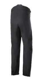 Alpinestars AMT Storm Gear Drystar® XF Pant, Black Motorcycle Overtrousers, rear view featuring a full circumference zippered waist connector, elasticated hems, and zippered leg openings for wet weather riding.