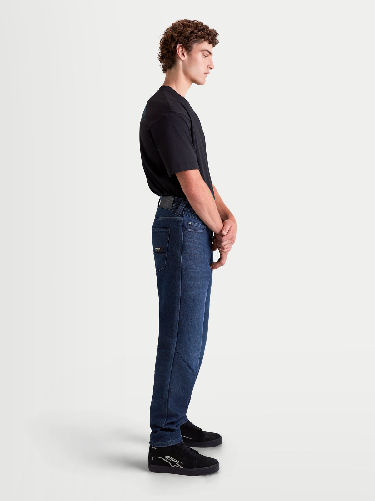 Alpinestars Flex-AST 10 Tough Max Denim Pants, men's motorcycle riding jeans in dark blue, side profile view of a model wearing AAA-rated single-layer technical denim with a regular tapered fit