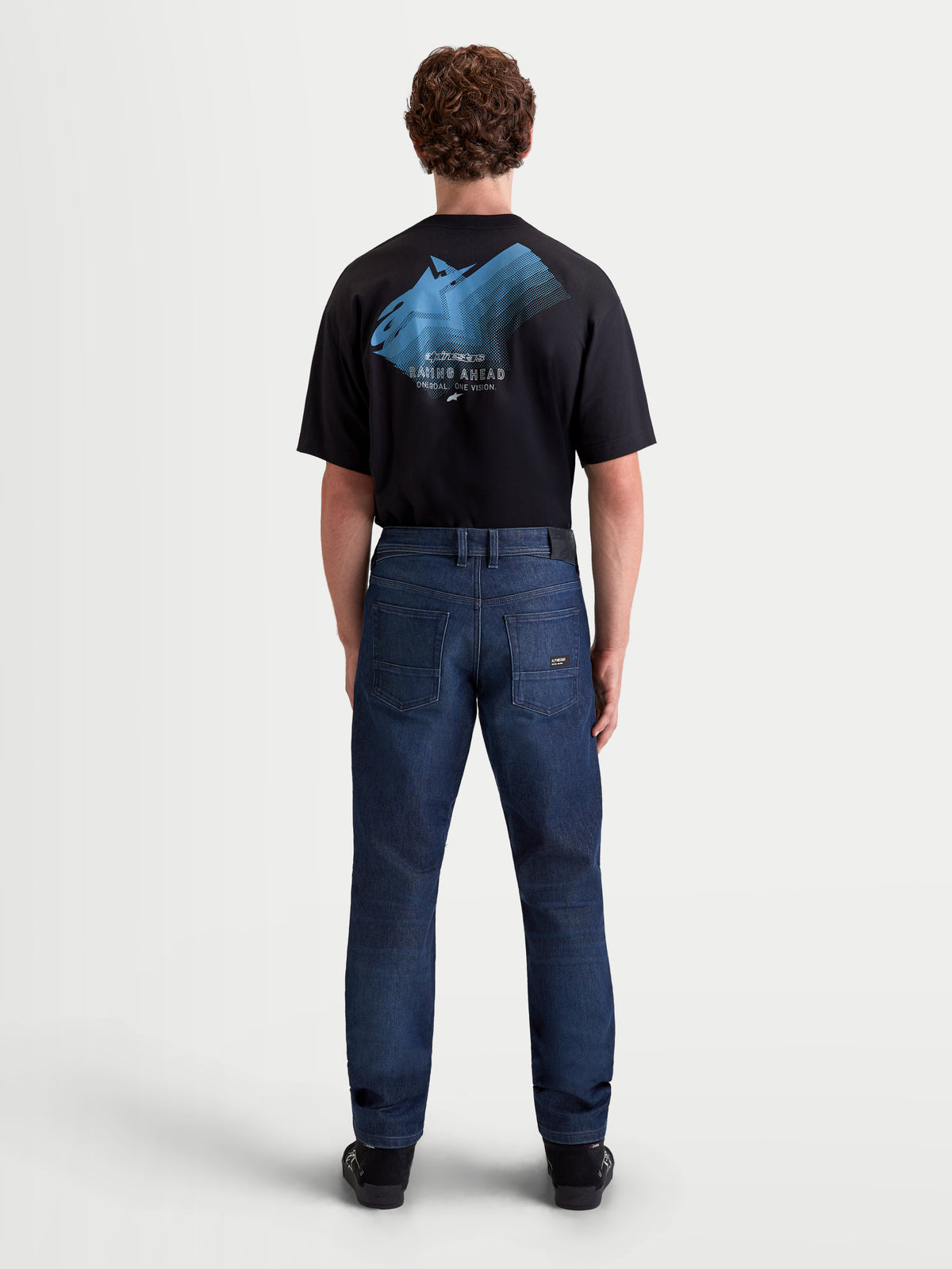 Alpinestars Flex-AST 10 Tough Max Denim Pants, men's urban motorcycle riding jeans in dark blue, rear view on a model wearing a black t-shirt, featuring single-layer technical denim and AAA-certified protection