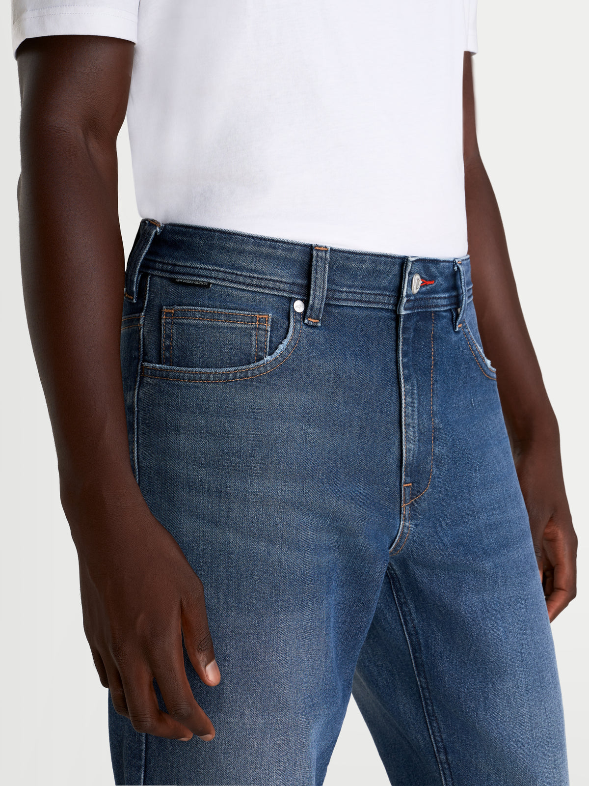 Alpinestars Flex-AST 8 Denim Pants Short, men's urban motorcycle riding jeans in medium blue, close-up view showing single-layer technical denim construction and five-pocket design worn by a model