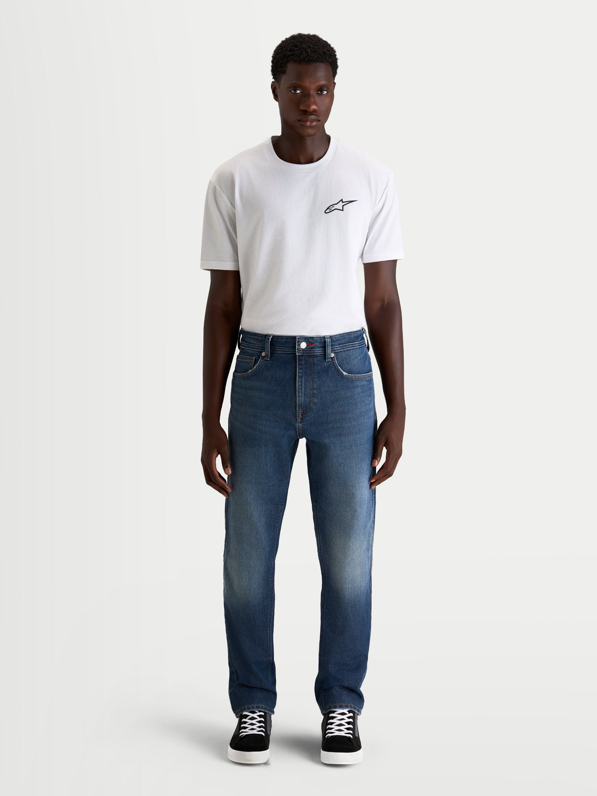 Alpinestars Flex-AST 8 Denim Pants Short, men's urban motorcycle riding jeans in medium blue, front view worn by a model wearing a white t-shirt, AA-certified protective single-layer denim with stretch comfort